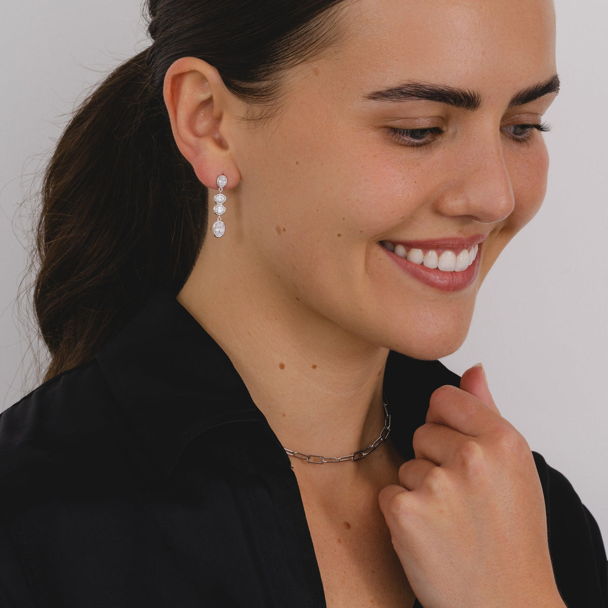 A pair of silver drop earrings with four cascading oval cut cubic zirconia's.