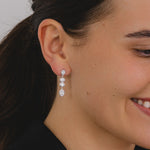 A pair of silver drop earrings with four cascading oval cut cubic zirconia's.