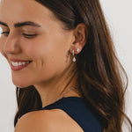 oval stud earrings with cubic zirconia's in a silver bezel setting