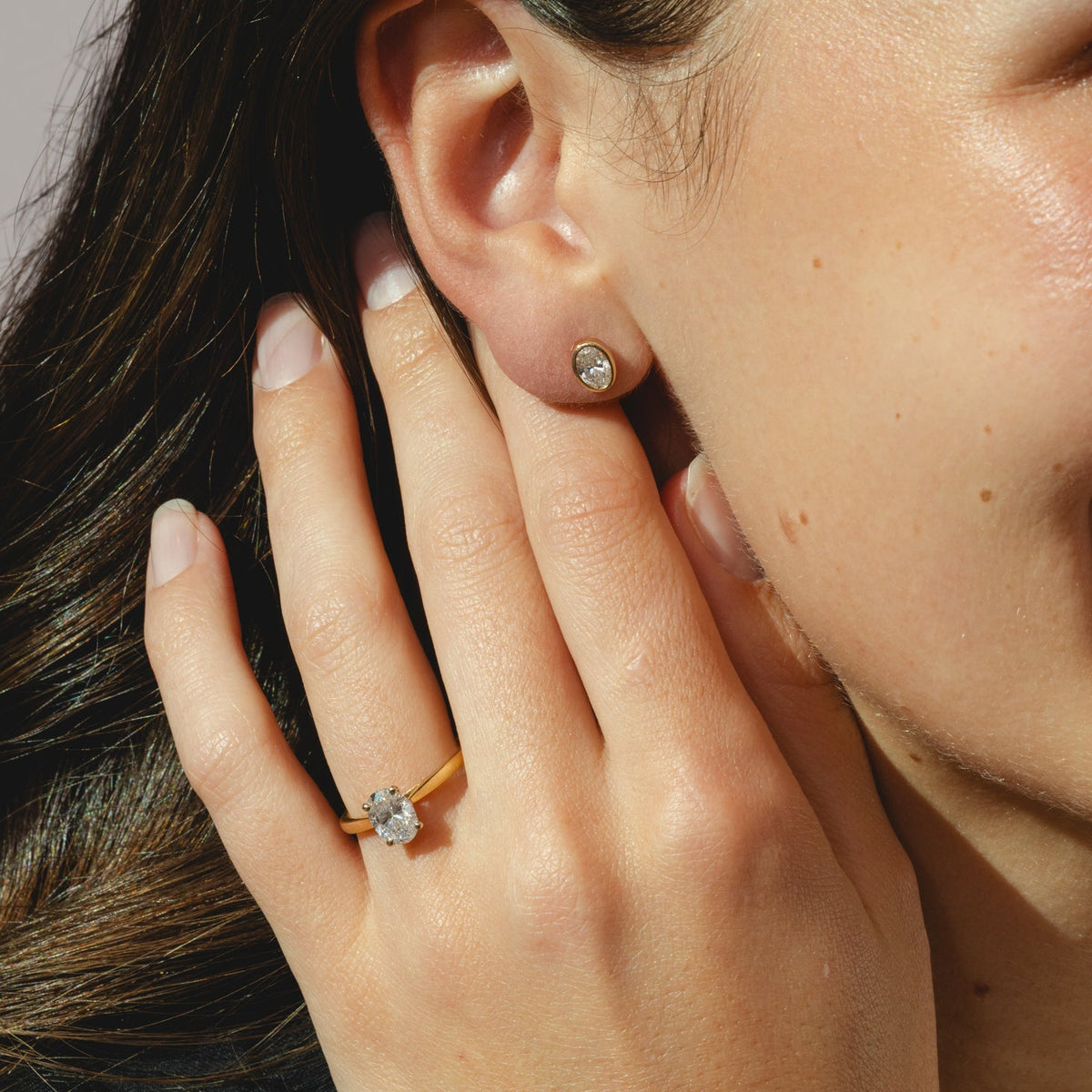 oval yellow gold stud earrings with 0.84ct diamonds in a bezel setting