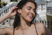 Model wears yellow gold link chain and mini bar necklace