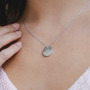 Model wears the lilywho round disc necklace. This pendant can be engraved, add an extra personal touch to your personalized chain with handwriting engraving. This necklace is made of sterling silver, and is available in three colours, gold plated, rose gold plated, and silver.