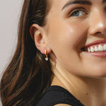 gold hoop earrings with heart cut 0.57ct diamond pendants.
