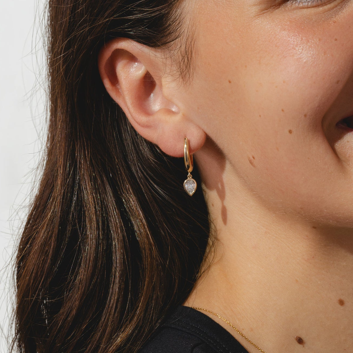 gold hoops with pear cut 0.8ct diamonds in bezel settings.