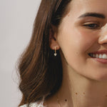 gold hoop earrings with heart cut 0.57ct diamond pendants.