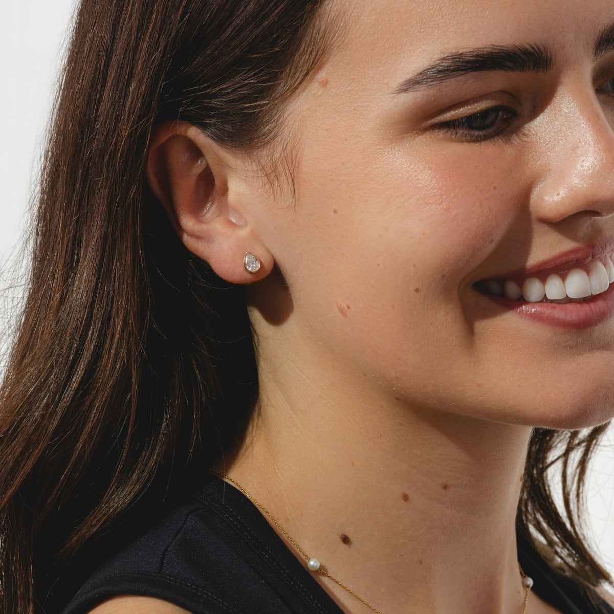gold stud earrings with pear cut 0.8ct diamonds in bezel settings