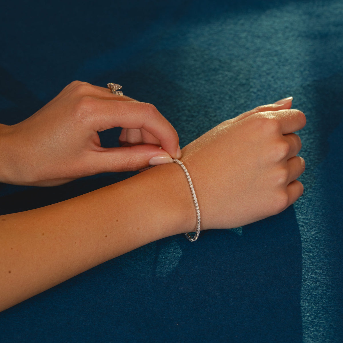 A platinum tennis bracelet with a row of clear round cut diamonds