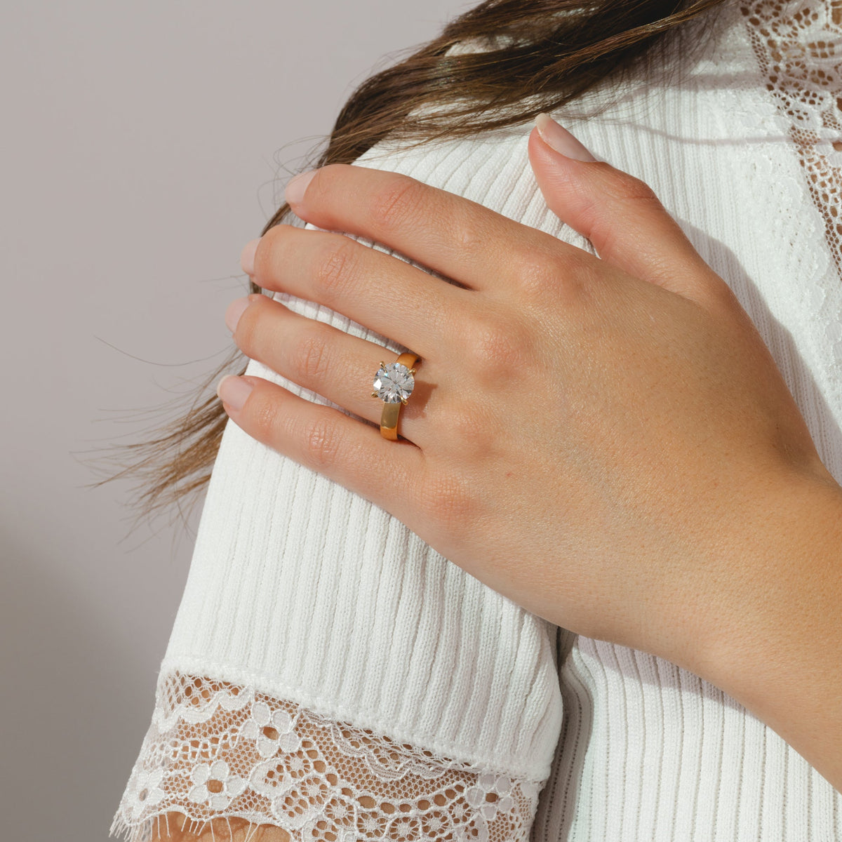 solitaire ring featuring a round cut 3ct diamond set in a yellow gold four prong band.
