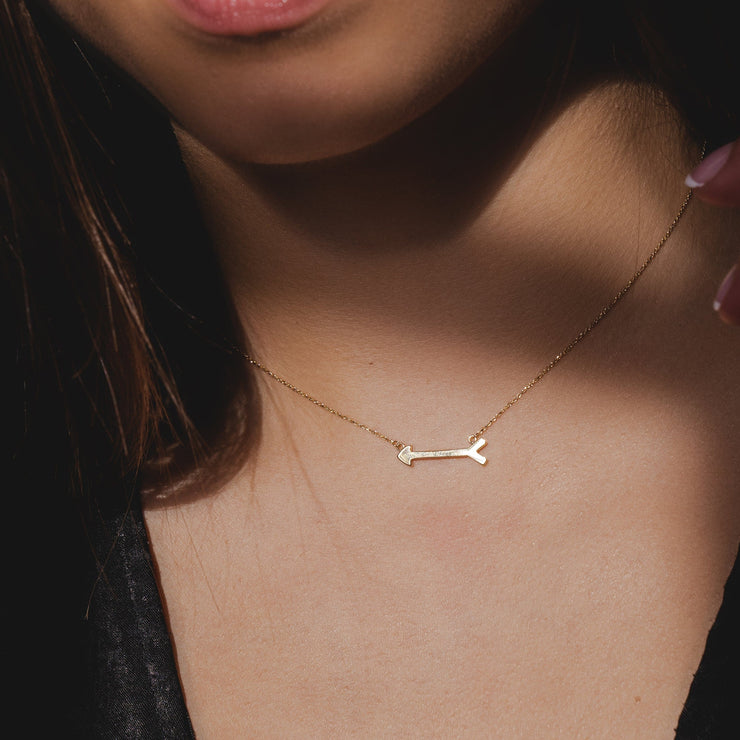 Model wears a 9ct gold arrow necklace. Arrow Necklace is made of 9ct gold.