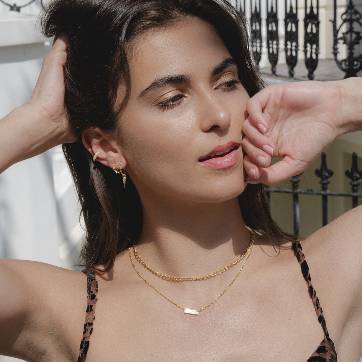 Model wears yellow gold link chain and mini bar necklace